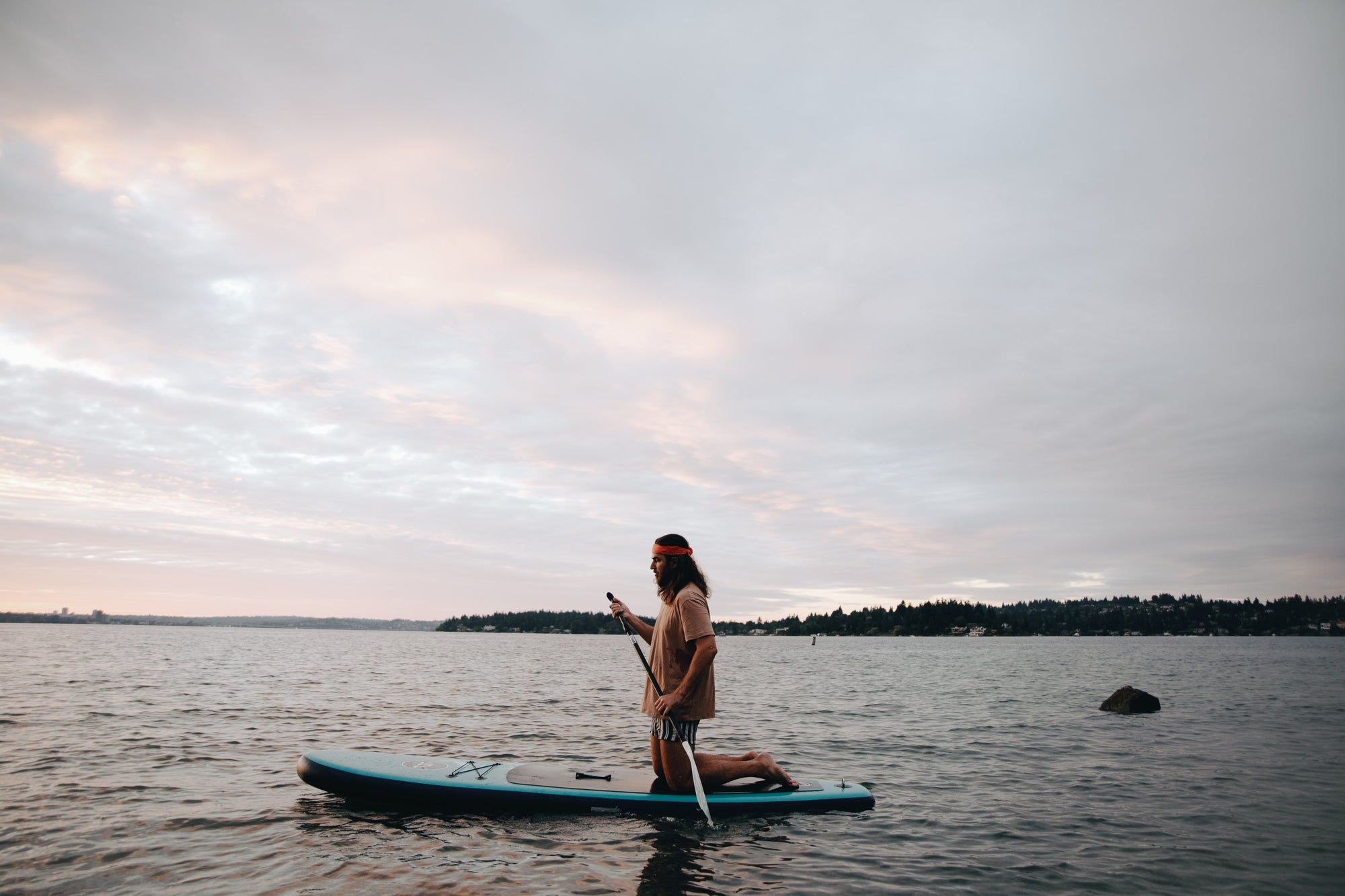 Active man paddle-boarding